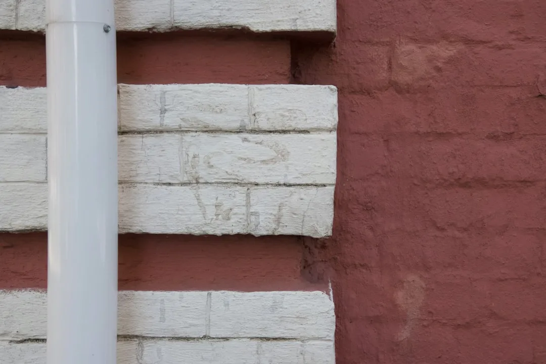 a white column against a red wall